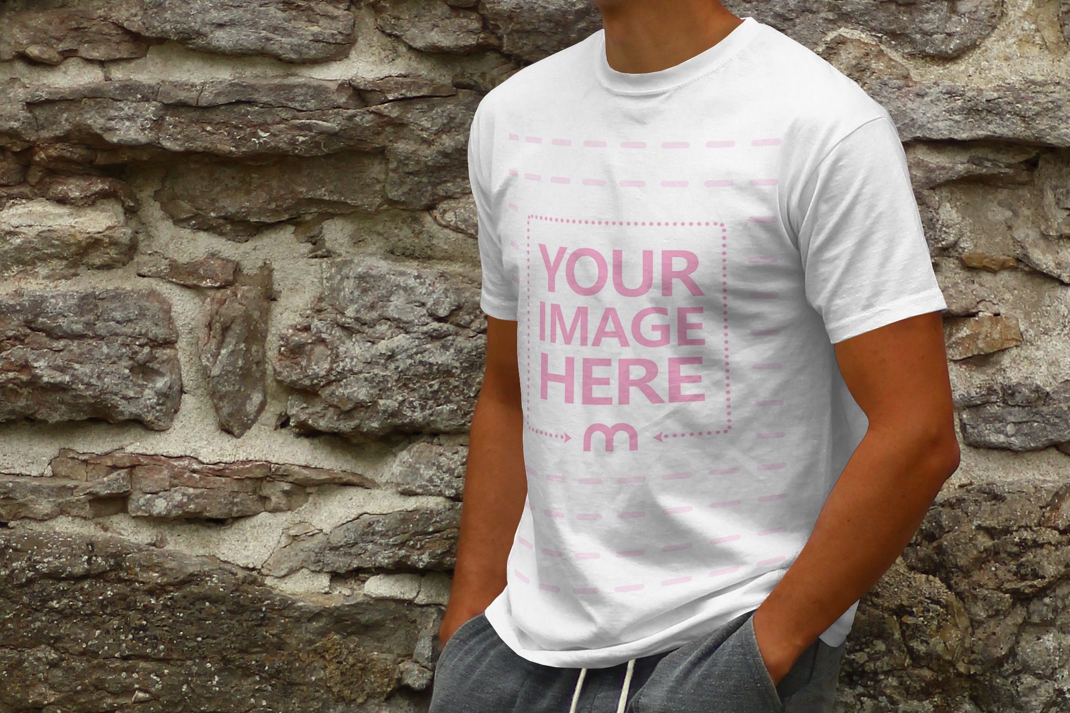 online t-shirt mockup generator template with a young man leaning against a stone wall