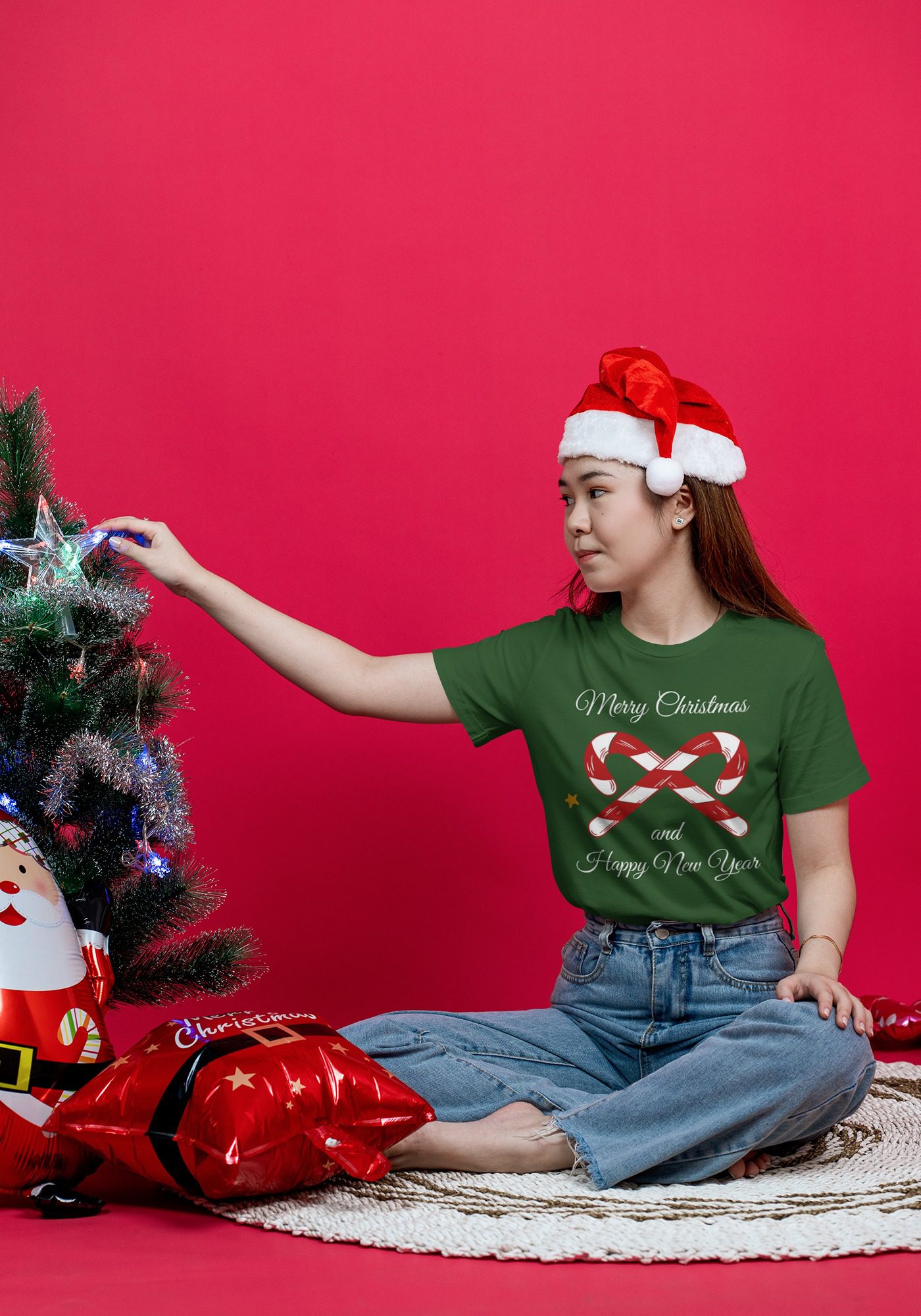 PSD Christmas T-Shirt Mockup Featuring a Woman Decorating | Mediamodifier